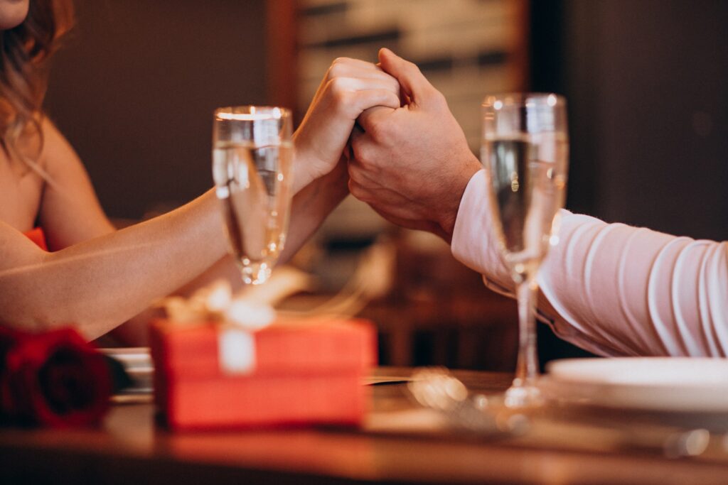 couple-holding-hands-valentines-evening-restaurant